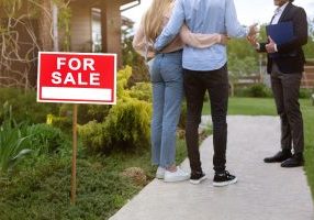 Buyers looking at residential property for sale, outside